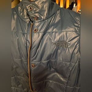 The North Face blue puffer vest size 6. Great condition